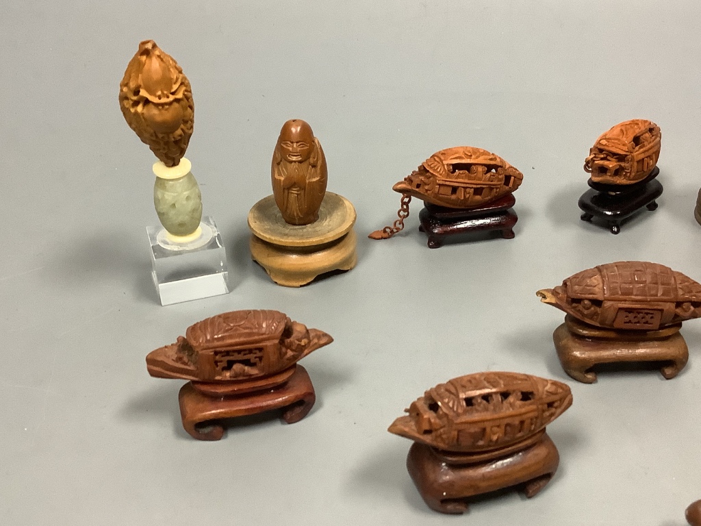 An assortment of Chinese peach stone and nut carvings